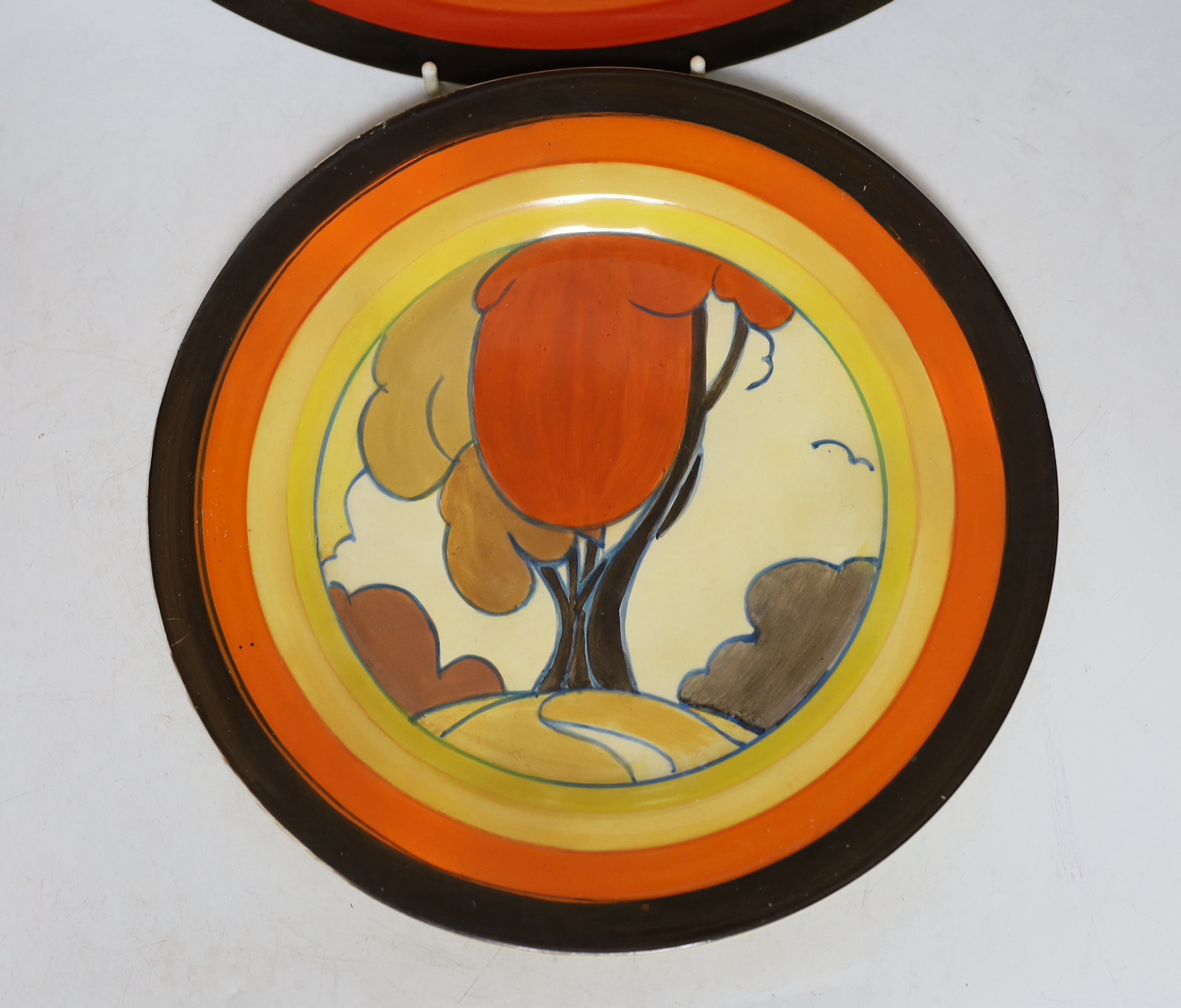 A Clarice Cliff 'Fantastisque' plate and another similar later Clarice Cliff style plate, largest 27cm diameter